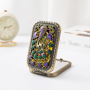 Vintage bronze folding pocket mirror with colorful peacock enamel and gemstone inlay