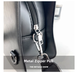 Close-up of premium silver zipper and metallic hardware on a black leather guitar bag