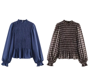 Detail of smocked honeycomb plaid blouse featuring ruffled cuffs and elastic textures