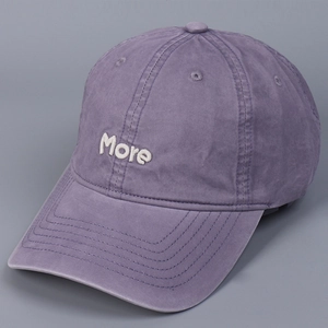 Close-up of purple washed cotton baseball cap featuring white More letter embroidery