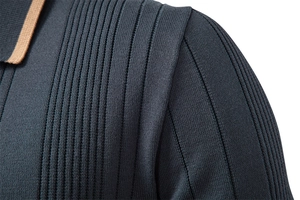 Detail of dark grayish blue ribbed knit sweater with contrasting khaki polo collar trim