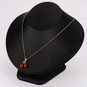 Gold stainless steel necklace featuring a cherry pendant on a black mannequin display