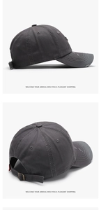 Close-up of dark gray washed cotton baseball cap with distressed holes and metal buckle