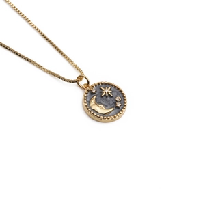 Gold plated moon and star pendant necklace with small crystals on a fine chain link