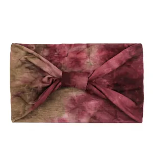Detail view of the soft tie-dye elastic headband with a stylish twist knot design