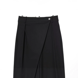 Minimalist black wide-leg pants featuring an asymmetric waist and single button detail