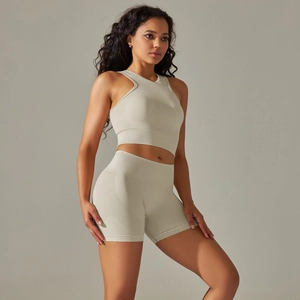 Detail of ribbed seamless knit fabric on beige yoga crop top and shorts set