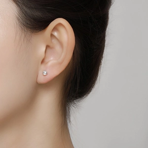 Minimalist S999 sterling silver ball stud earrings shown on model for women
