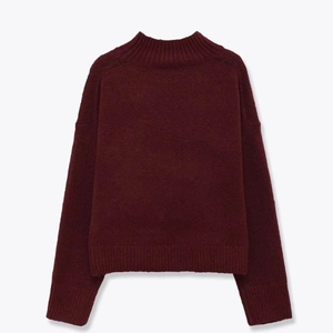 Burgundy mock neck knit sweater with soft texture and ribbed cuffs on white background