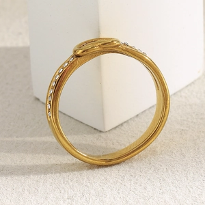 Detailed close-up of a 18K gold-plated slim heart ring with delicate micro-pave crystal inlay