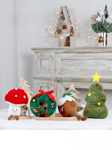 Close-up of plush Christmas ornaments including mushroom, wreath, and star tree on a mantel