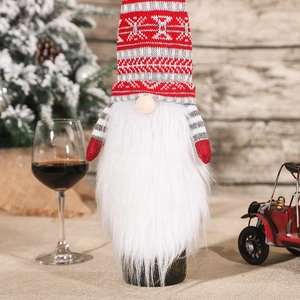 Knitted Christmas gnome wine bottle cover with a long white beard and a pointed hat