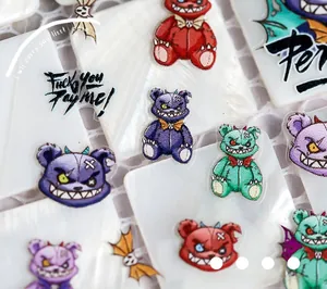 Detailed close-up of 5D embossed bear nail art stickers with street style lettering