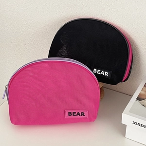 Detailed view of semi-circle mesh makeup bags with BEAR label and contrast zippers