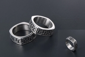 Macro detail of silver titanium steel rings featuring vintage Greek fret Greca patterns