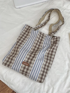 Vintage plaid patchwork canvas tote bag with shoulder straps and brand label detail