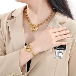 Set aus vergoldeter Kette und Armband mit Adlerflügel-Anhänger und OT-Verschluss