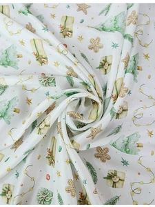 Detailed view of watercolor Christmas tablecloth with trees and gingerbread man patterns