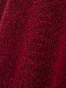 Macro shot of deep red mohair knit fabric showing soft texture and fuzzy wool fibers