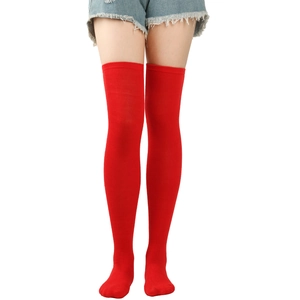 Detail view of red over-the-knee socks showing the ribbed knit texture and tight fabric