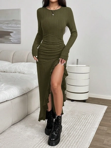 Detail of dark green knit dress with vertical ribbing and elegant side ruffle hem