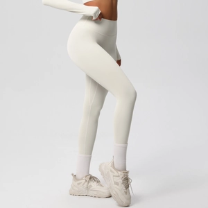 Detailed side view of high-waisted cream yoga leggings with wide tummy control waistband