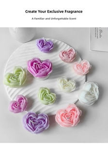 Detailed macro shot of heart-shaped floral scented candles in soft macaron pastel colors