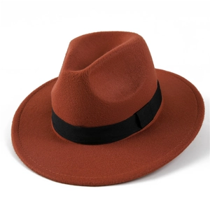 Detail of rust red wool fedora hat featuring a classic black grosgrain ribbon band