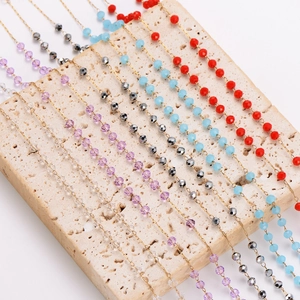 Long crystal necklaces in red blue and purple on stone display for Christmas gift