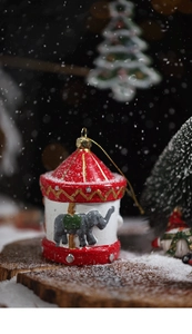 Detailed view of carousel ornament with grey elephant on festive Christmas background