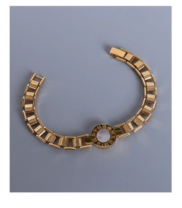 Detailed macro view of golden Roman numeral bracelet with white shell inlay