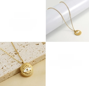 Close-up of 18k gold plated titanium steel necklace with evil eye pendant detail