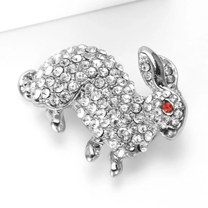 Close-up of rabbit brooch in silver alloy with sparkling rhinestones and red stone eyes