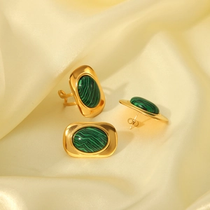 Detail of green malachite stone inlay on gold stainless steel ring and earrings set