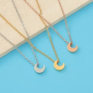 Detailed view of crescent moon necklaces in silver, gold, and rose gold finishes