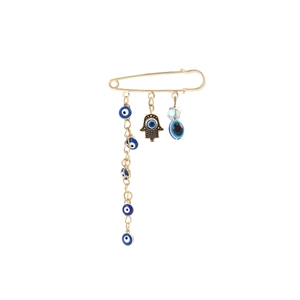Detail of golden safety pin brooch featuring blue evil eye charms and Hamsa hand pendant