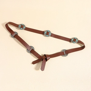 Detail of vintage brown leather belt featuring silver metal discs with turquoise beads