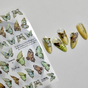 Detail of 3D embossed butterfly nail stickers with green finish on nail art tips