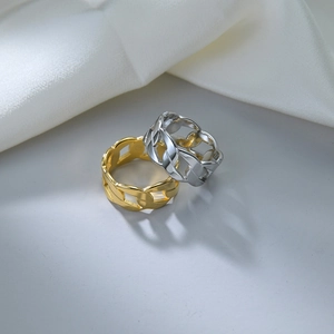 Detail view of 9mm punk chain rings in gold and silver finish on white silk