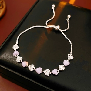 Detail of adjustable silver bracelet with lavender and clear heart-shaped stones
