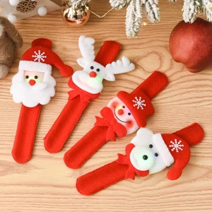 Luminous Christmas snap bracelets featuring Santa, Reindeer, and Snowman on wood background