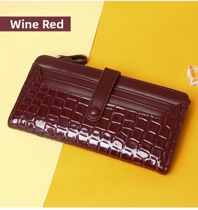 Detail of claret long wallet showing crocodile pattern texture and smooth leather finish
