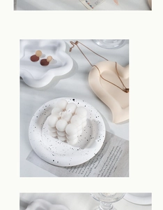 Overhead view of heart and cloud shaped jewelry display trays with a bubble candle