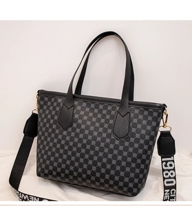 Detail of vintage tote bag with circular patterns and detachable graphic shoulder strap
