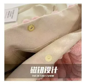 Detail showing the magnetic buckle closure on a pink plush tote bag with fabric lining