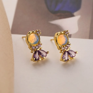 Detailed close-up of 18K gold plated earrings with opal stones and purple teardrop gems