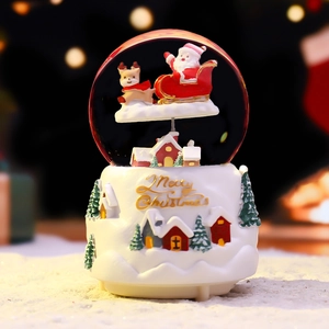 Christmas snow globe with white base and Santa sleigh resin figurine
