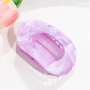 Macro detail of the purple marble pattern on the flat acrylic hair claw clip surface