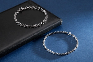 Detailed view of silver stainless steel rolo chain bracelets with lobster clasps