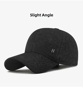 Detail view showing a textured black winter wool baseball cap with metal N logo pin
